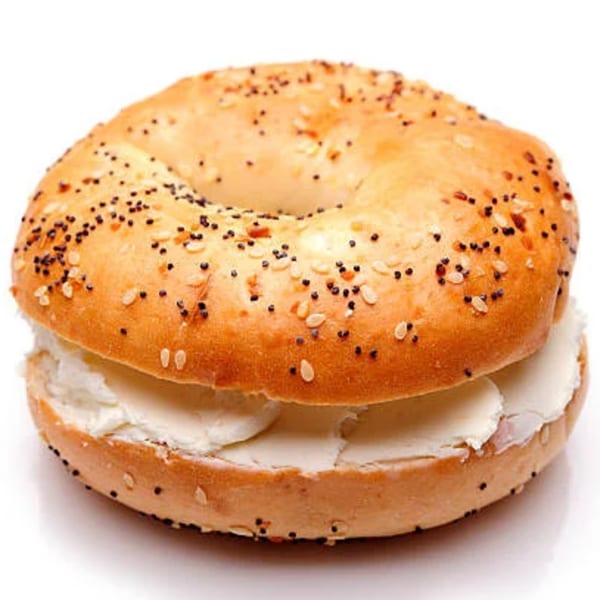 Everything bagel with poppy seeds and sesame seeds, filled with a generous layer of cream cheese.