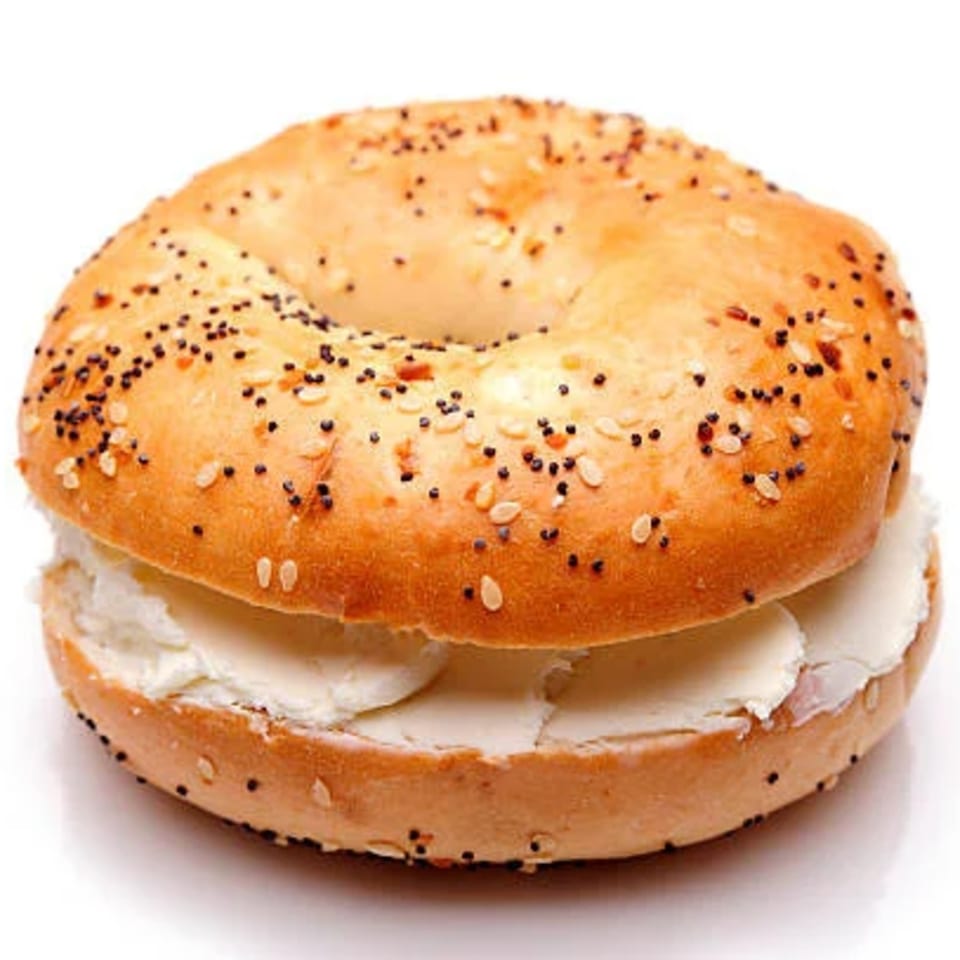 Everything bagel with poppy seeds and sesame seeds, filled with a generous layer of cream cheese.